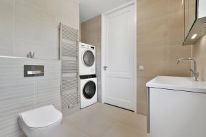 Bathroom with toilet and washing machine, toilet and sink in Apollo Beach FL